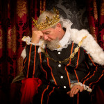 Pensive and worried king sitting on his throne